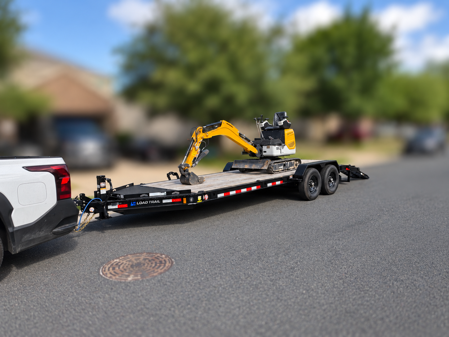 Equipment trailer carrying a vehicle